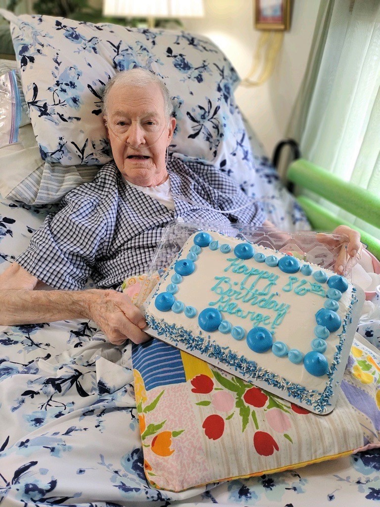 George displays his birthday cake. 