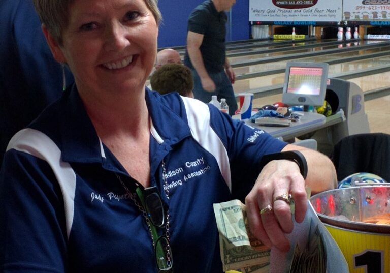 Judy Poynter of the Madison County Bowling Association happily counts funds raised at a recent Lemetta Dause Memorial Tournament.  This year's event is Feb. 4.