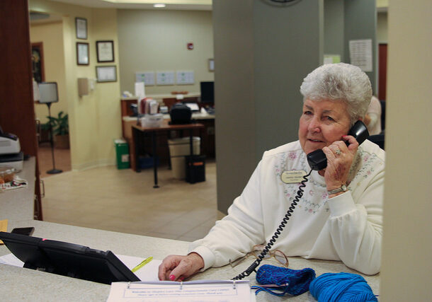 Jelemia Sanders, a 20-plus year volunteer at Hospice Care Plus, answers phones at the Compassionate Care Center.