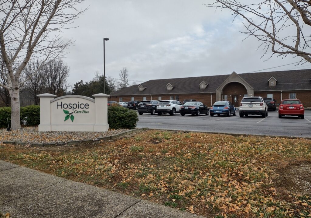 The Hospice Care Plus Berea office building, shown with cars in the lot and the Hospice Care Plus sign in front.