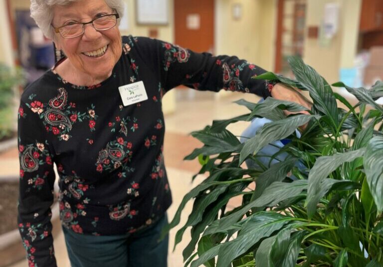 Front Desk Volunteer, Cora LePorin does more than answer phones. She makes plants happy wherever she goes.