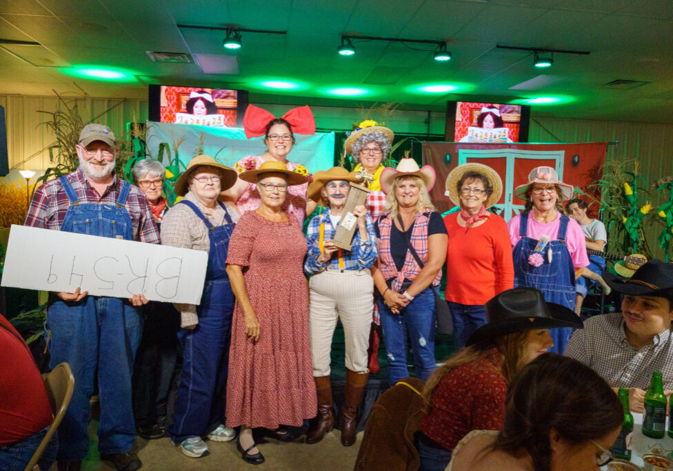 The River City Players Community Theater group accepts the first-place prize in the table-decorating contest.