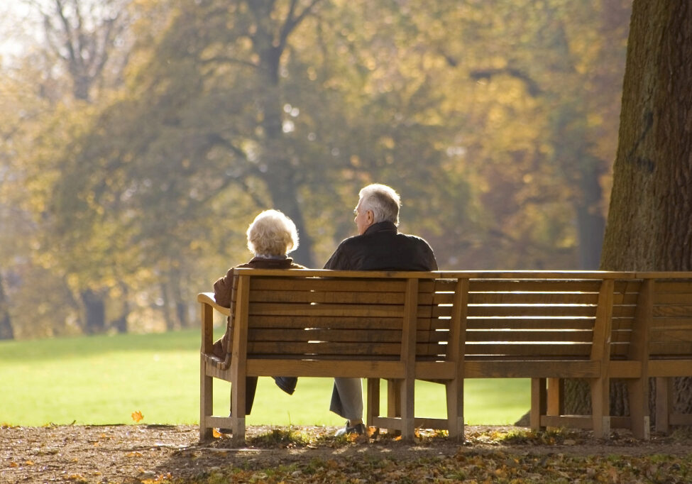 Couple sitting on park bench